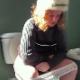 A blonde woman takes a piss and a super-long shit while sitting on a toilet during a cold day while wearing winter clothing. She is seen from multiple angles, including some close-up facial shots. Presented in 720P HD. Over 4 minutes.